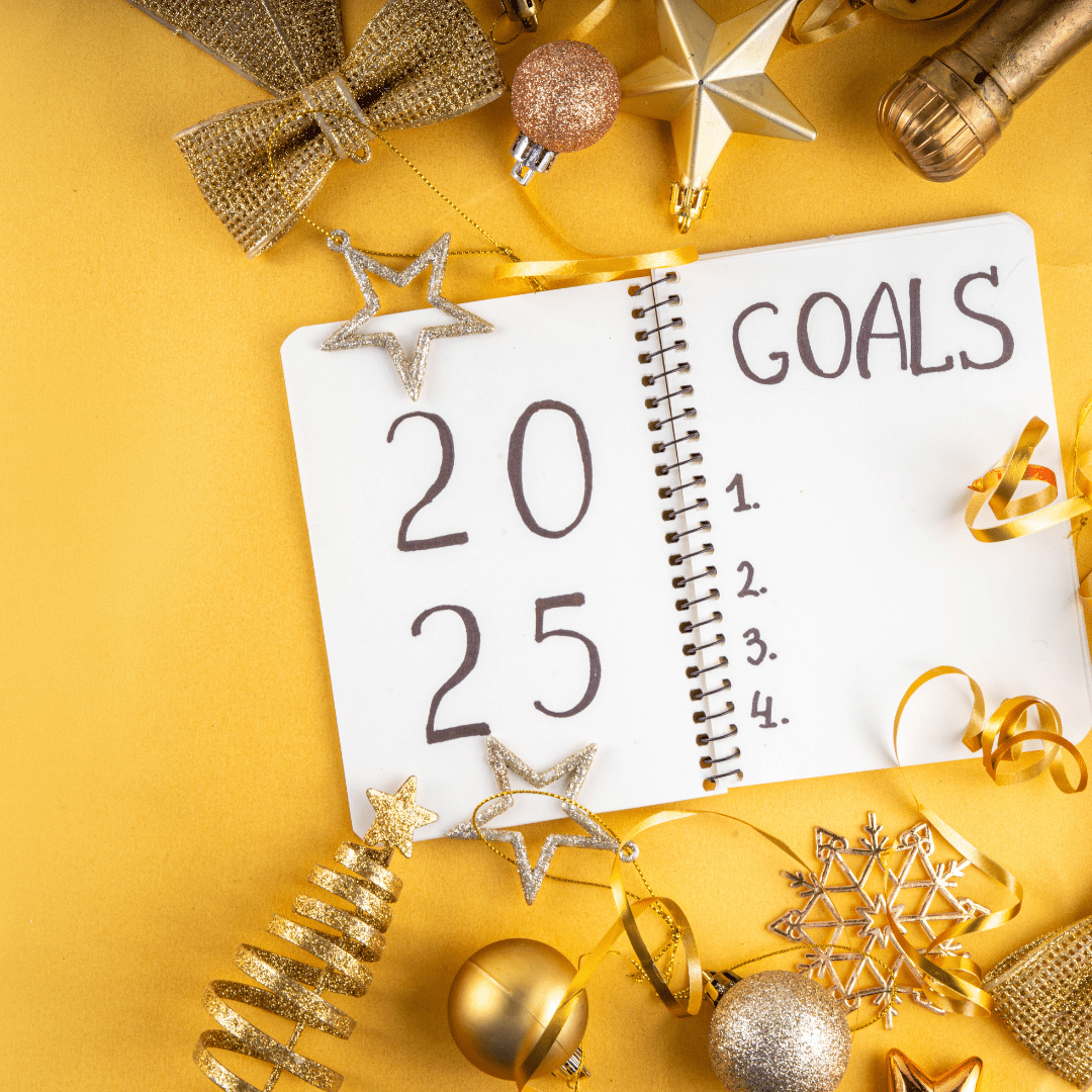 A notebook with "2025 Goals" and four blank spaces is surrounded by gold and bronze holiday decorations on a yellow background.